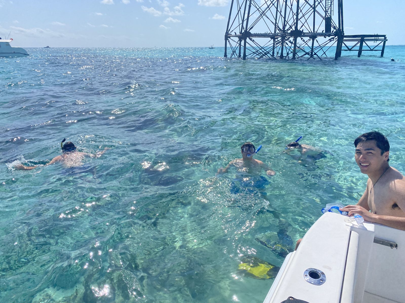 Snorkelers in clear turquoise water near Alligator Reef
