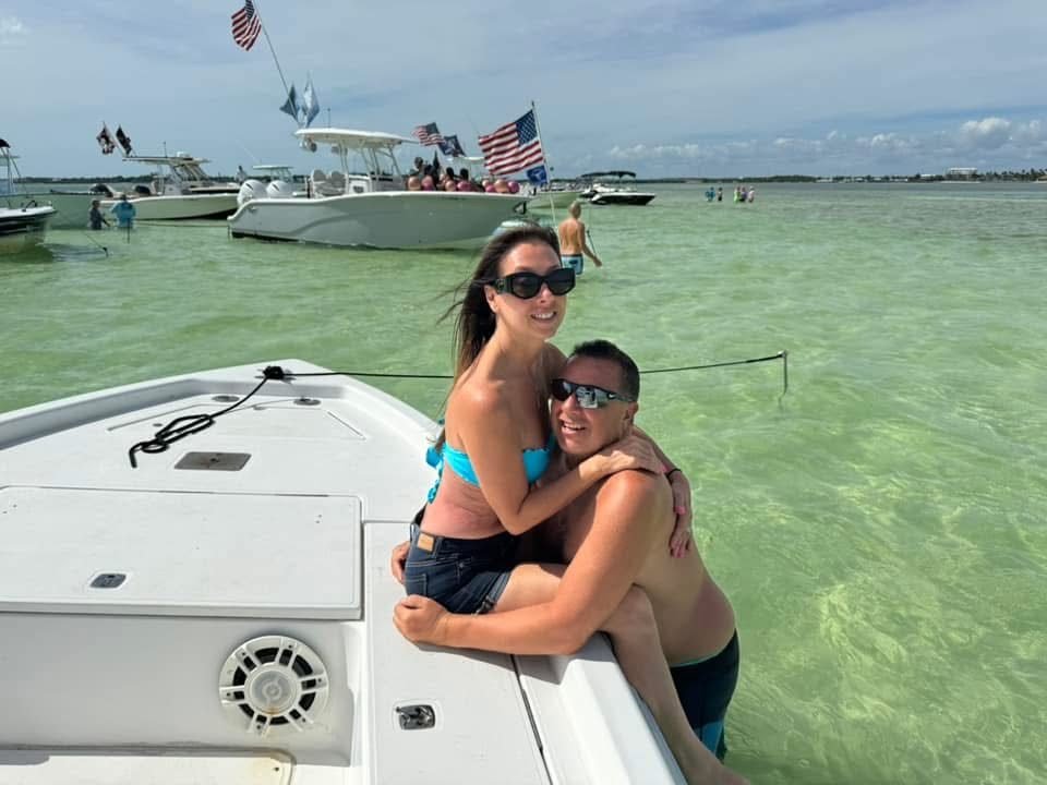 Couple on the boat at the Islamorada sandbar with crystal-clear water