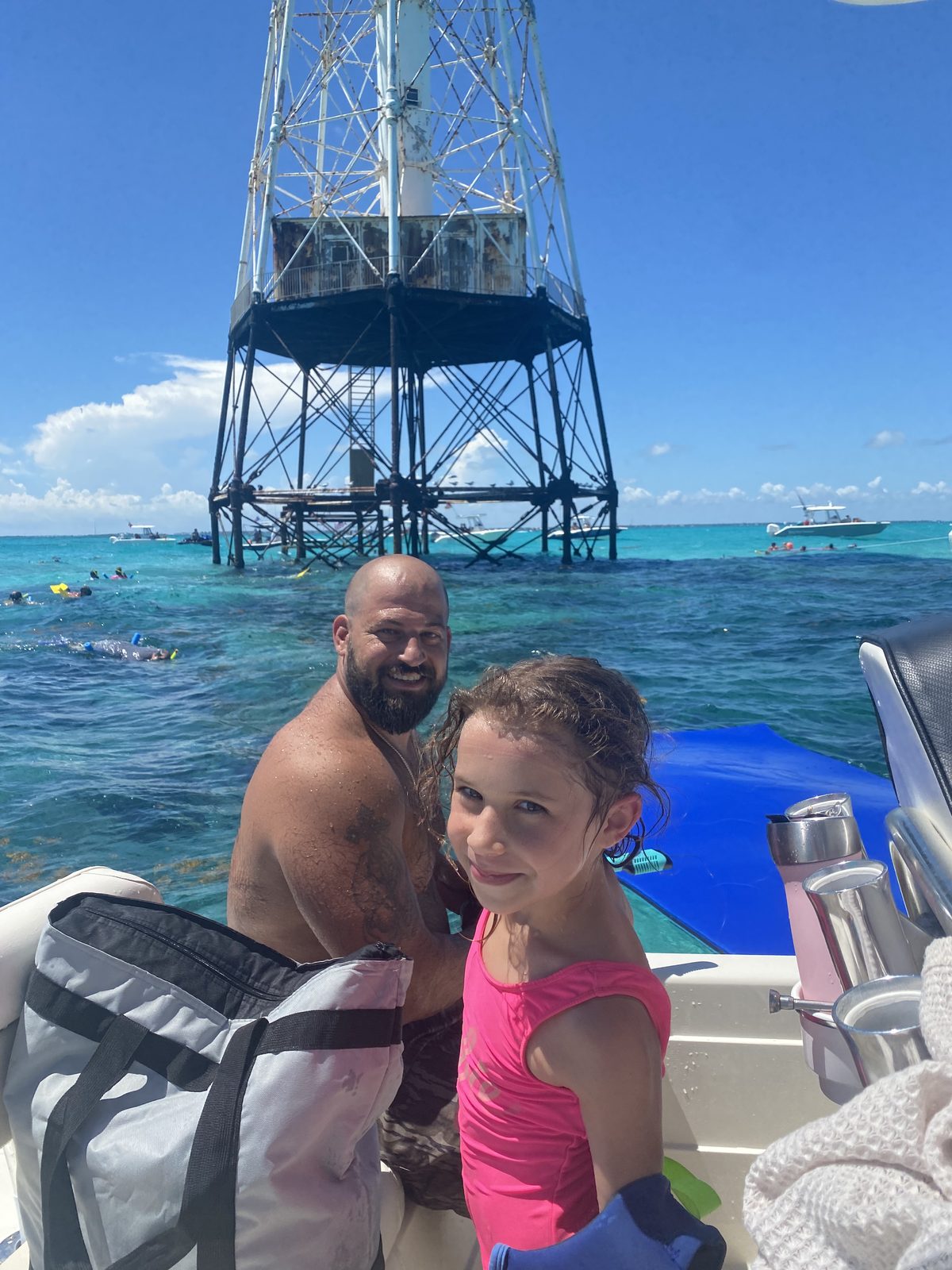 Captain Rene with a young guest at Alligator Reef Lighthouse, ready to snorkel