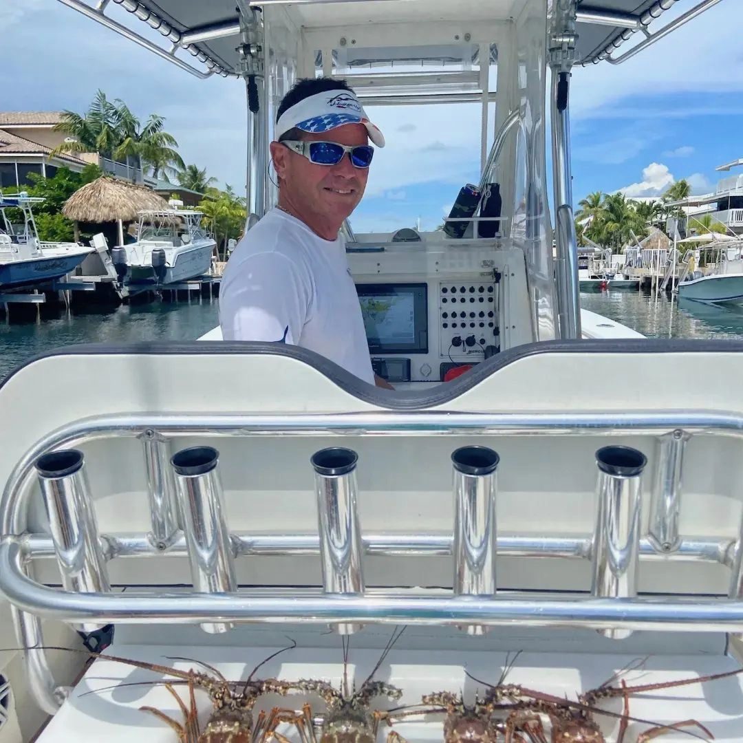 Captain Rene at the helm of his boat returning with a catch of Florida lobster in Islamorada